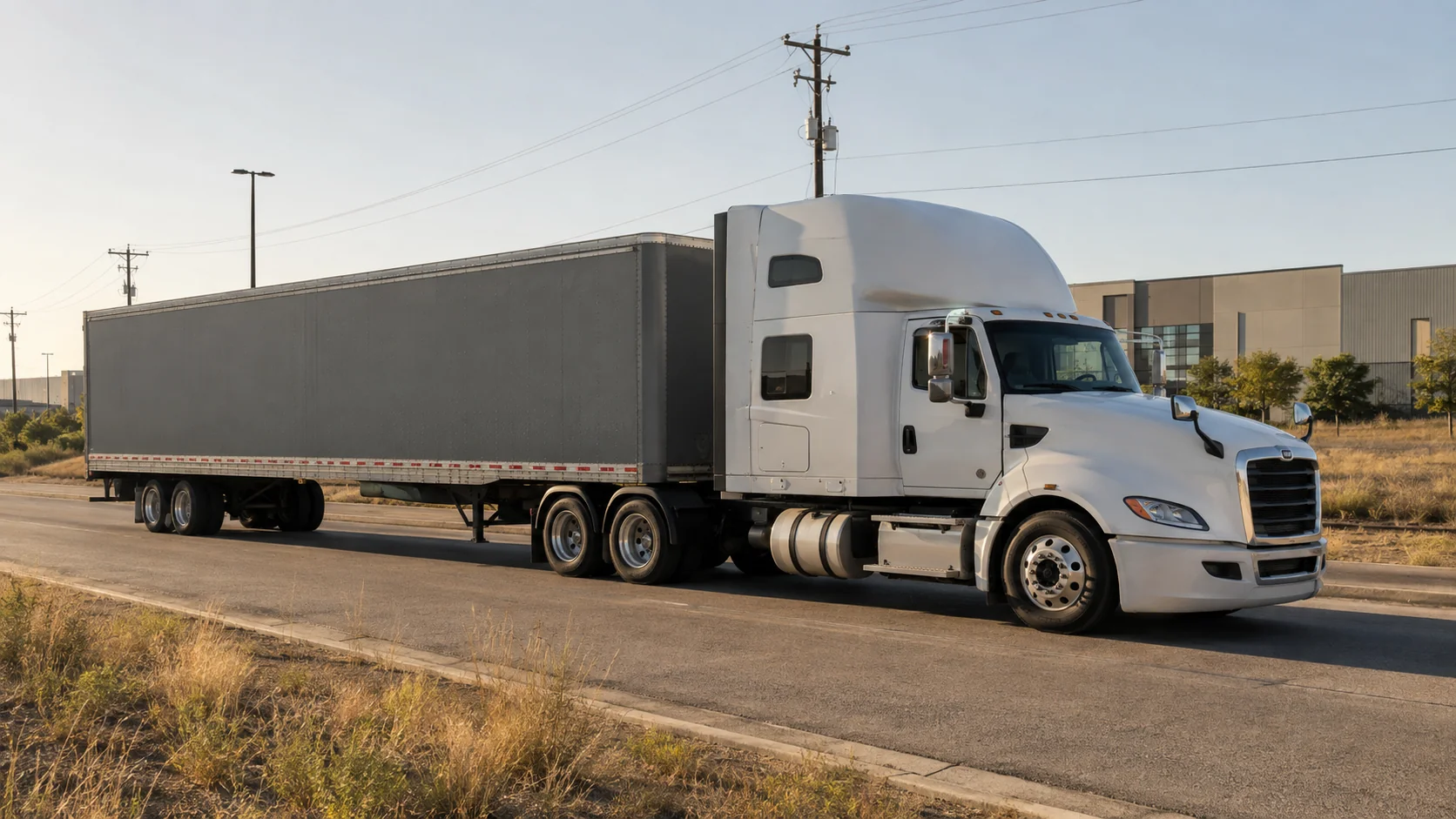Unbranded tractor-trailer traveling on an industrial road in the Austin area